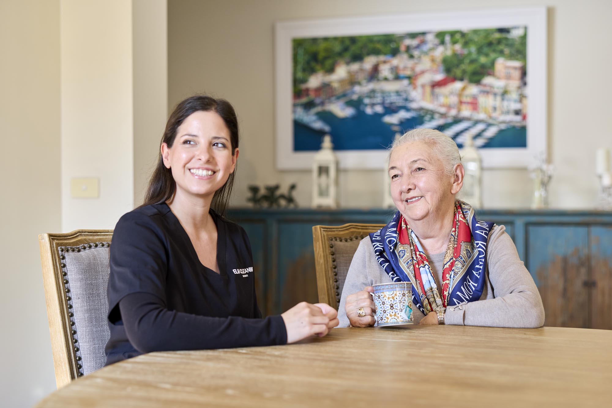 ELM cleaner sitting with an elderly client