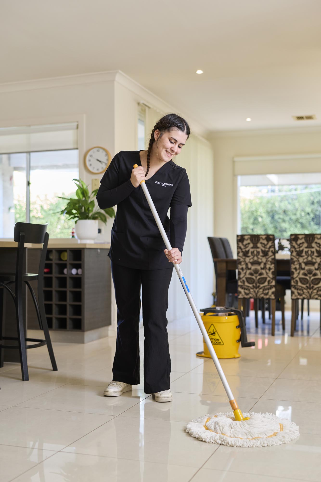 ELM cleaner mopping a tiled floor